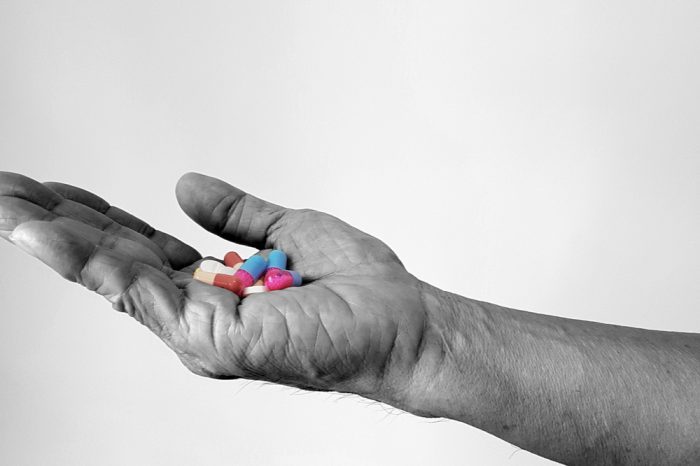 hand holding opioids for chronic pain and quality of life