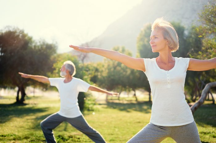 solution for chronic pain represented by older adult couple doing yoga maybe after cbd