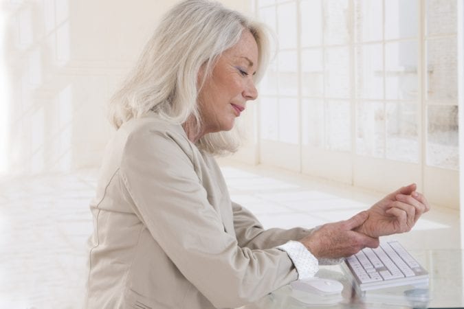 older woman perhaps thinking about whether she needs CBD or THC for pain relief