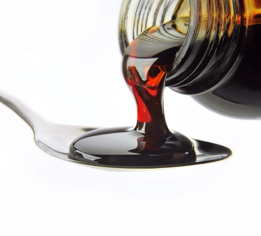 Close up Cough Syrup Poured Onto Spoon, drugs