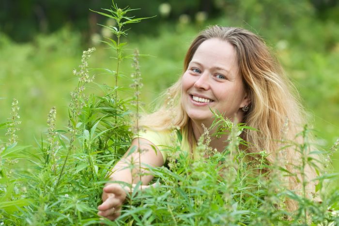 woman in front of hemp plants