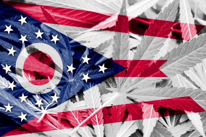 ohio flag imposed over cannabis leaves