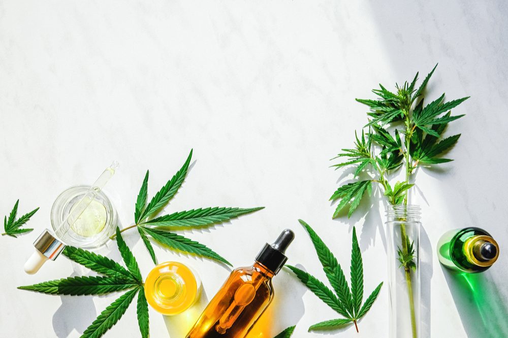 weed washing represented by cannabis product bottles laying with leaves